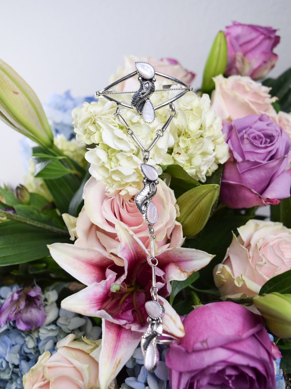 The Preslea Mother of Pearl Bracelet attached to a Ring
